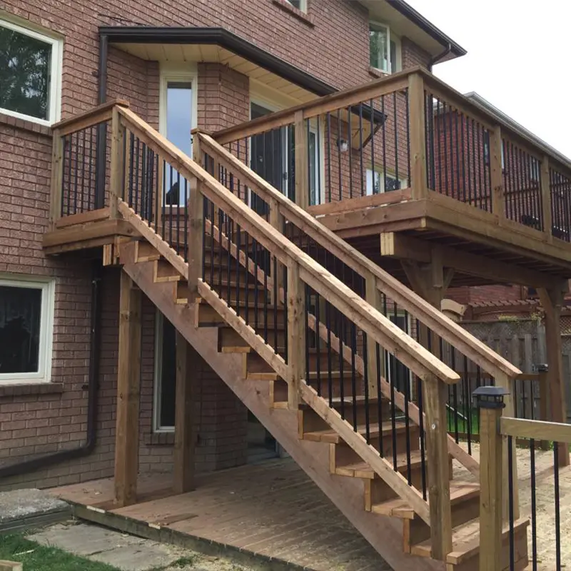 Backyard deck stairs with wood handrails and black aluminum balusters installed by Megapol Deck in GTA.