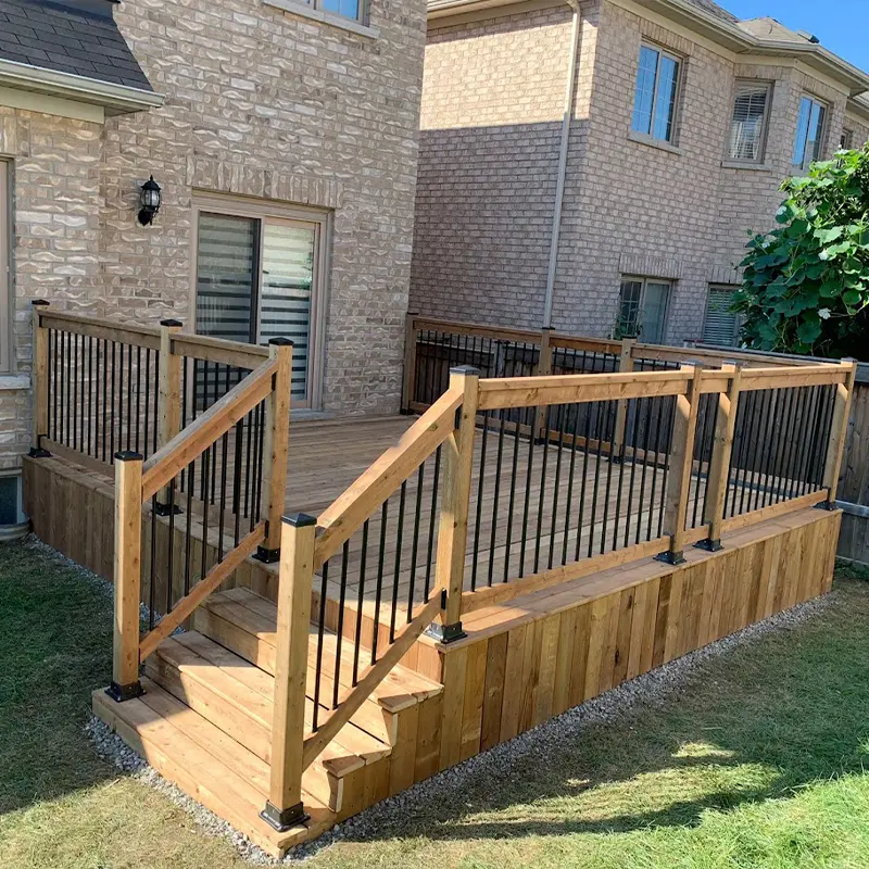 Backyard pressure-treated wood deck with black aluminum railing installed by Megapol Deck in GTA.
