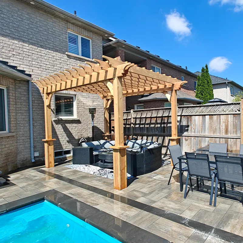 Cedar pergola installation over interlock patio by Megapol Deck in GTA backyard.