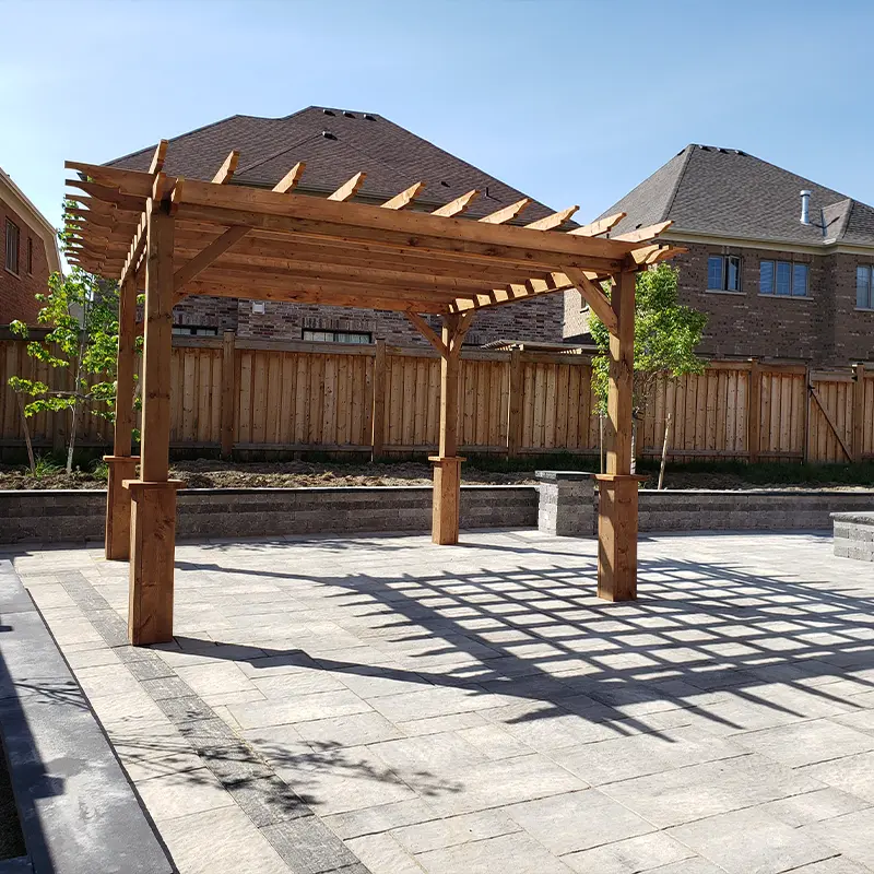 Custom cedar pergola installation over interlock patio by Megapol Deck in GTA backyard.