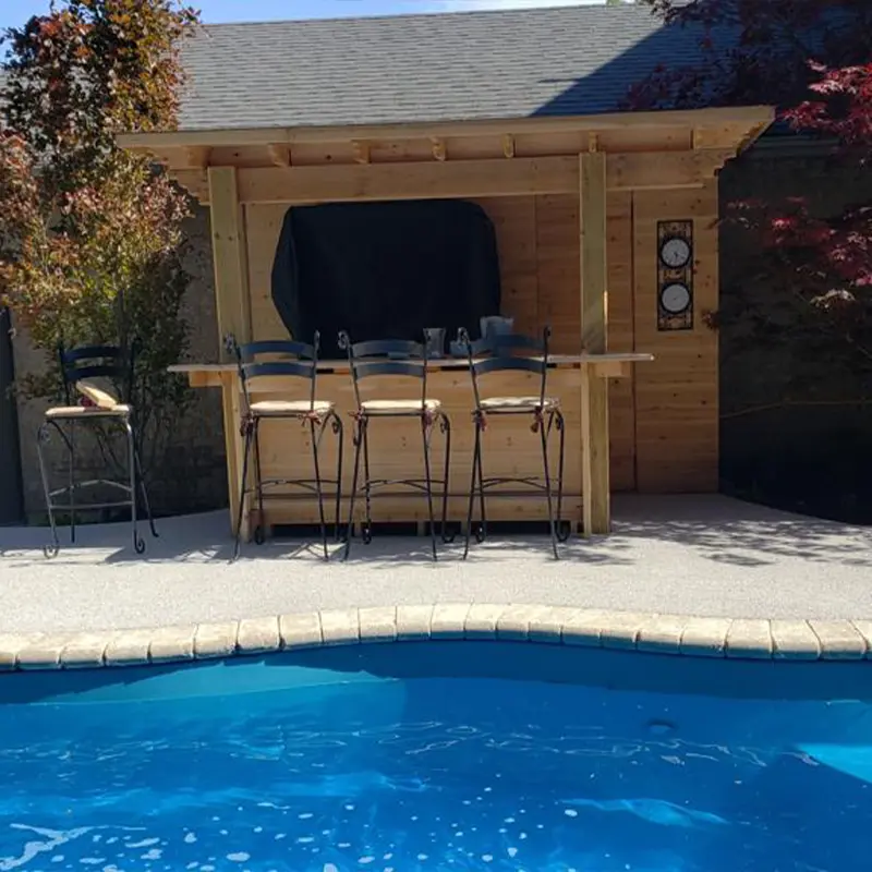 Custom wood poolside cabana with outdoor bar seating built by Megapol Deck in GTA.