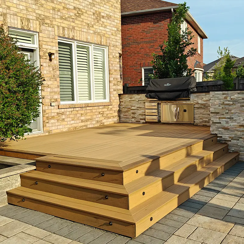 Modern composite deck with wide steps built by Megapol Deck in GTA backyard featuring integrated stair lighting.