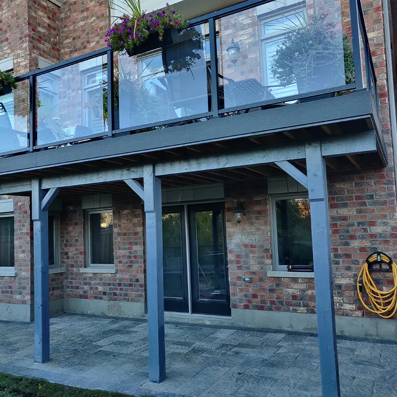 Modern glass deck railing system installed by Megapol Deck in GTA with aluminum framing.