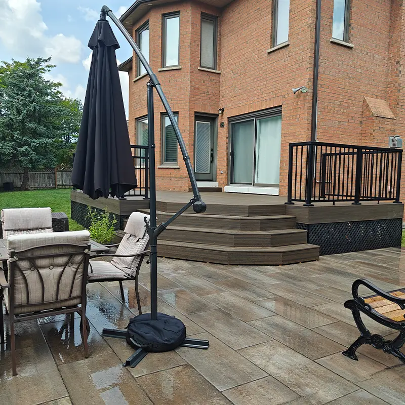 Multi-level composite deck with black railing system installed by Megapol Deck in GTA backyard.