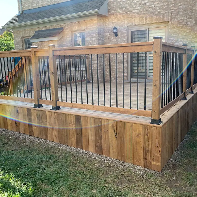 Wood deck with black aluminum baluster railing system installed by Megapol Deck in GTA backyard.